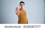 Man, portrait and stop with hand out in studio for rejection, no or halt on a white background. Male person, model or disapproval with palm for warning, termination or cease fire on mockup space