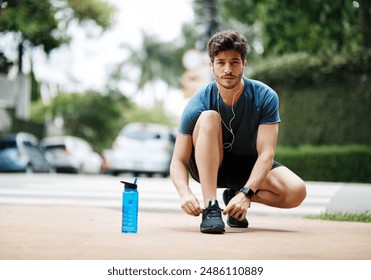 Man, portrait and tie shoes for exercise, fitness and preparation to run marathon on road. Outdoor, male person and sneakers lace before training, workout and ideas of runner for sports journey - Powered by Shutterstock