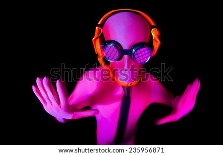 a man poses inside a pink UV glow suit