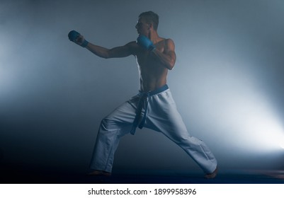 The man posing at Aikido training in martial arts school. Healthy lifestyle and sports concept
