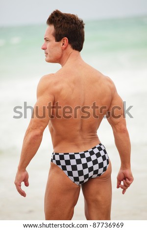 Man posing with back turned towards the camera