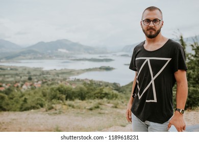 Man posing in front of the lake