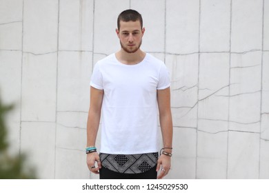 man posing in front of marble wall