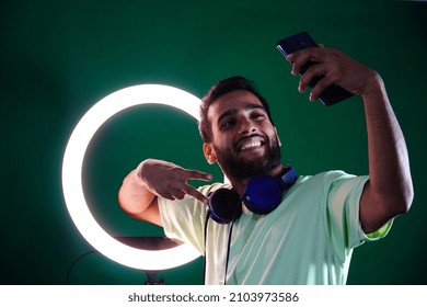 man posing in front of the ring light
