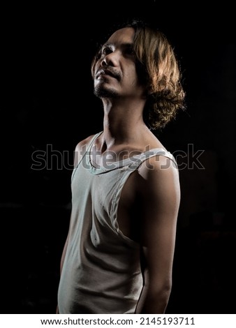 a man posing in lowkey photography