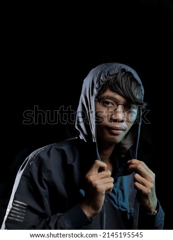 a man posing in lowkey photography