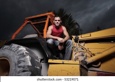 Man Posing On Heavy Machinery At Night