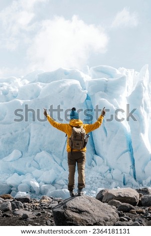 A man posing on the ice formation of the Perito Moreno glacier, Argentina