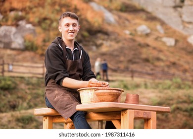 Man Potter Work With Clay Ware. Young Handsome Man Potter On His Workshop. 