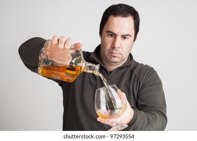 Man Pouring  A Glass Of Whiskey On Casual Clothes