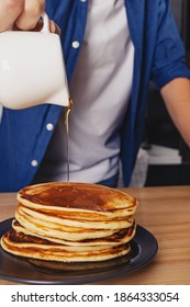 Man Pouring With Maple Syrup On The Stack Of Pancakes