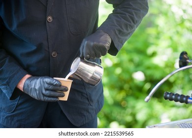 A Man Pouring Milk In A Carton Cup