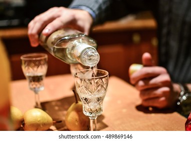 Man Pouring Strong Alcoholic Drink Vodka In Glass