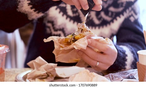 Man Pouring Tahini Onto His Falafel Sandwich In A Restaurant For Lunch.  Slow Motion 4K Video.