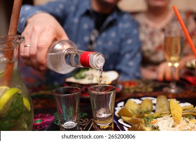 Man Pouring Vodka In The Asian Restaurant