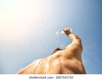 Man Pouring Water From Plastic Bottle On His Head In Hot Day