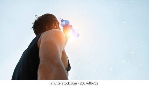 Man Pouring Water From Plastic Bottle On His Head In Hot Day