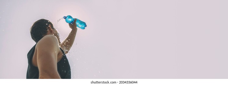 Man Pouring Water From Plastic Bottle On His Head In Hot Day