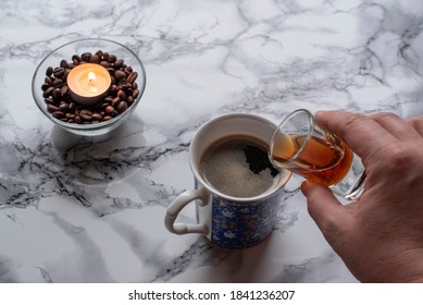 Man Pours Amaretto Into Coffee