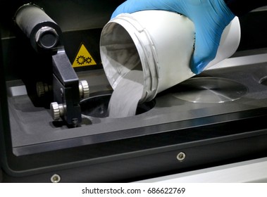 man pours metal powder into the chamber of a laser sintering machine. 3D printer printing metal. Modern additive technologies 4.0 industrial revolution