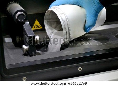 man pours metal powder into the chamber of a laser sintering machine. 3D printer printing metal. Modern additive technologies 4.0 industrial revolution