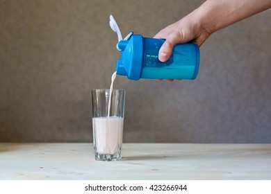 The Man Pours The Protein From The Shaker Into The Glass
