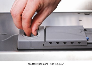 A Man Pours A Rinse Aid Into The Dishwasher Compartment.