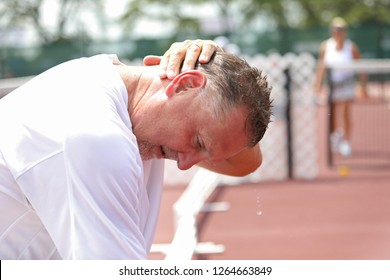 A Man Pours Water Over His Head Trying To Cool Down In The Summer Heat