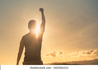 Man, power, victory, winning, hero concept. Strong young muscular male with fist in the air. - Shutterstock ID 1425361211