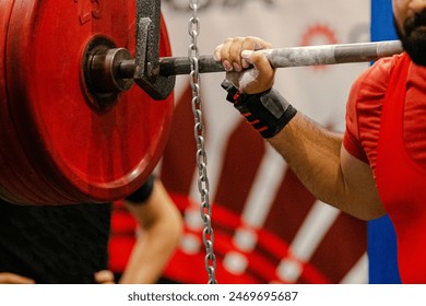 man powerlifter starting squat exercise at powerlifting competition