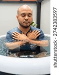 Man practices cold therapy and ice bathing in inflatable tub, using Wim Hof Method for wellness, meditation, fitness recovery, sports therapy. Wellness and healthy lifestyle.