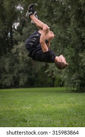 Man Practices Parkour And Free Running By Doing A Backflip