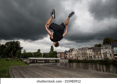 Man Practices Parkour And Free Running By Doing A Backflip 