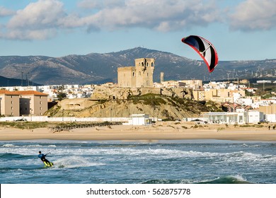 Man practicing kitesurfing on the beach of Tarifa, Spain. Tarifa is considered the capital of the wind, and favorite place for lovers of this sport.