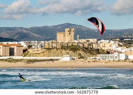 Man practicing kitesurfing on the beach of Tarifa, Spain. Tarifa is considered the capital of the wind, and favorite place for lovers of this sport. Foto stock © 
