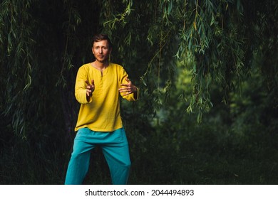 Man Practicing Neigong In Nature Near The Foliage