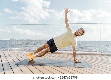 Man Practicing Side Plank Exercise by the Waterfront During a Sunny Day