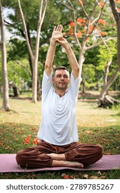 Man practicing yoga exercise and flexibility training outdoors in natural park environment for healthy lifestyle wellness fitness and mindfulness balance.