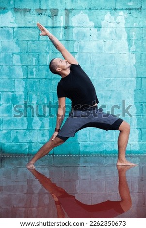 Similar – Mexican yoga teacher practicing side angle pose