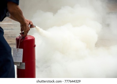 A man practises how to use a fire-extinguisher