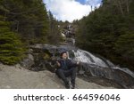 Man in praise while  looking out from elevation on Mount Washinton via Ammonoosuc ravine trail in Coors County,  New Hampshire.