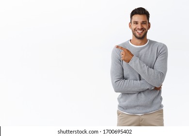 Man Praising Great Concept, Pointing Left At Your Project As Discuss Corporate Staff Coworker. Attractive Pleased Businessman In Grey Casual Sweater Having Chat And Recommend Check-out Product