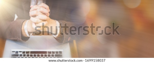 A man praying by faith with computer laptop\
,Church services online concept, Online church at home concept,\
spirituality and religion.