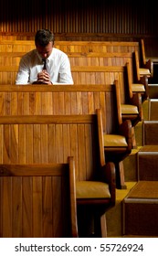 A Man Praying In Church