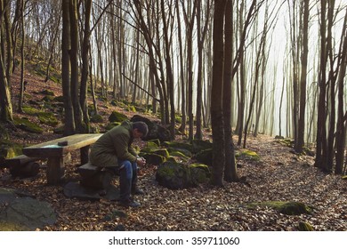 Man Praying in Forest