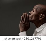 man praying to god with hands together Caribbean man praying with black grey background with people stock image stock photo	