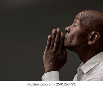 man praying to god with hands together Caribbean man praying with black grey background with people stock image stock photo	