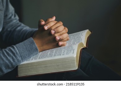 Man praying hands clasped together on  Bible. Christian life crisis prayer to god. Man Pray for god blessing to wishing have a better life.  believe in goodness. spirituality and religion.prayer bible