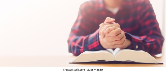 Man Praying On Holy Bible With Wooden Block Word Bible.Worship Faith And Read Bible Online At Home.Bible Study In Home Church, Wisdom Of GOD, Holy Spirituality , Worship And Christian.Prayer Pray.