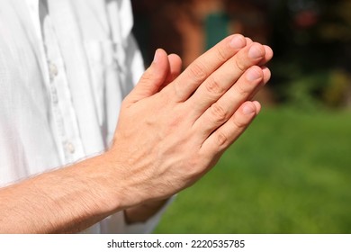 Man Praying Outdoors On Sunny Day, Closeup